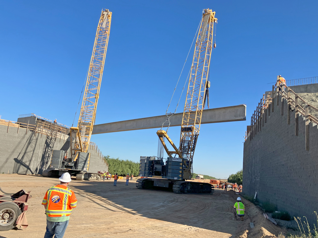 Crews from Tutor-Perini/Zachry/Parsons Joint Venture placing pre-cast girders at the Avenue 9 Grade Separation in Fresno County. Each girder spanned 172-feet long, is 7 feet tall and weighed more than 210,100 pounds. This is the first four of nine girders to be placed at the Avenue 9 overcrossing.